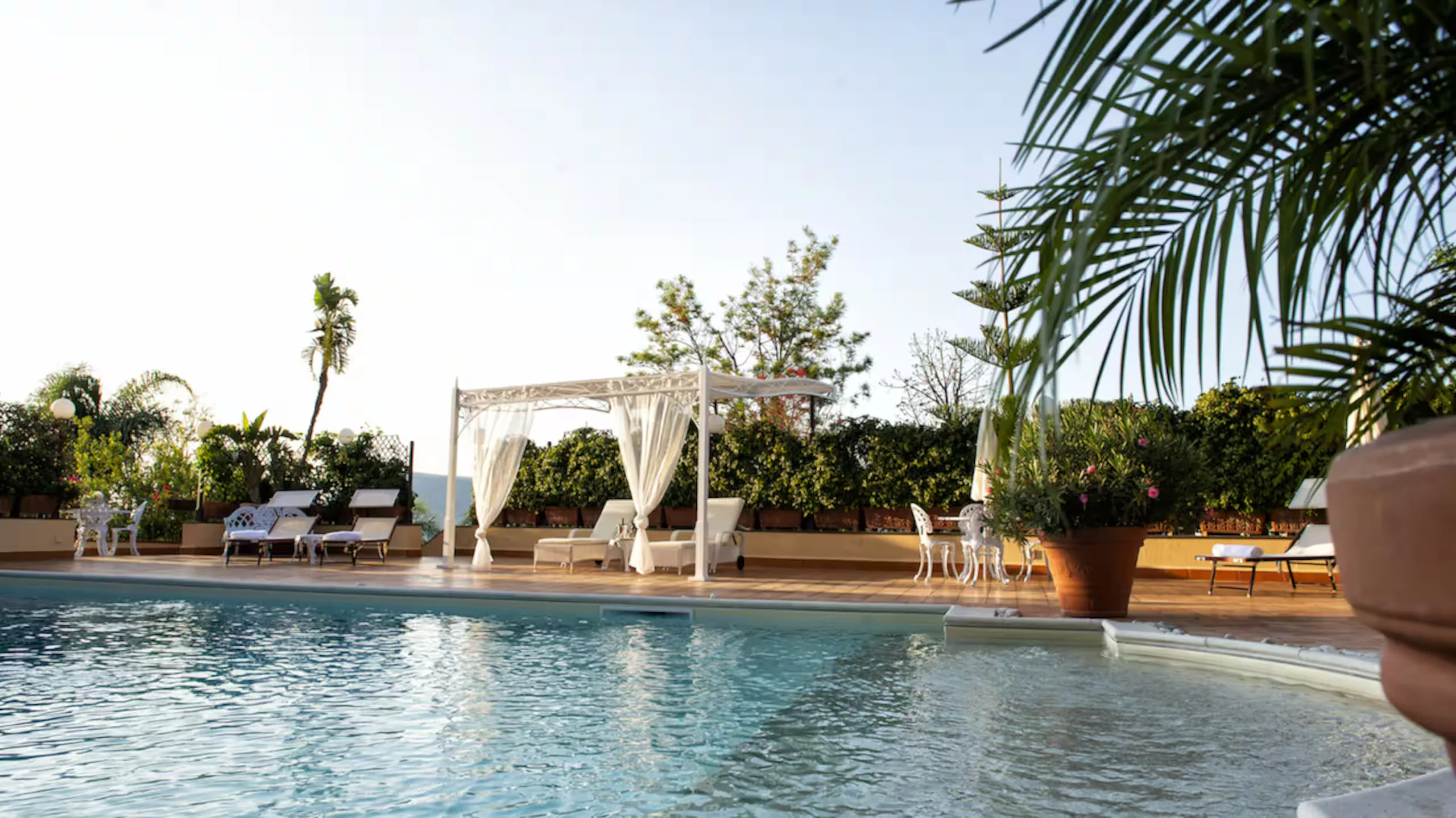 The pool, the loungers and the curtained cabana